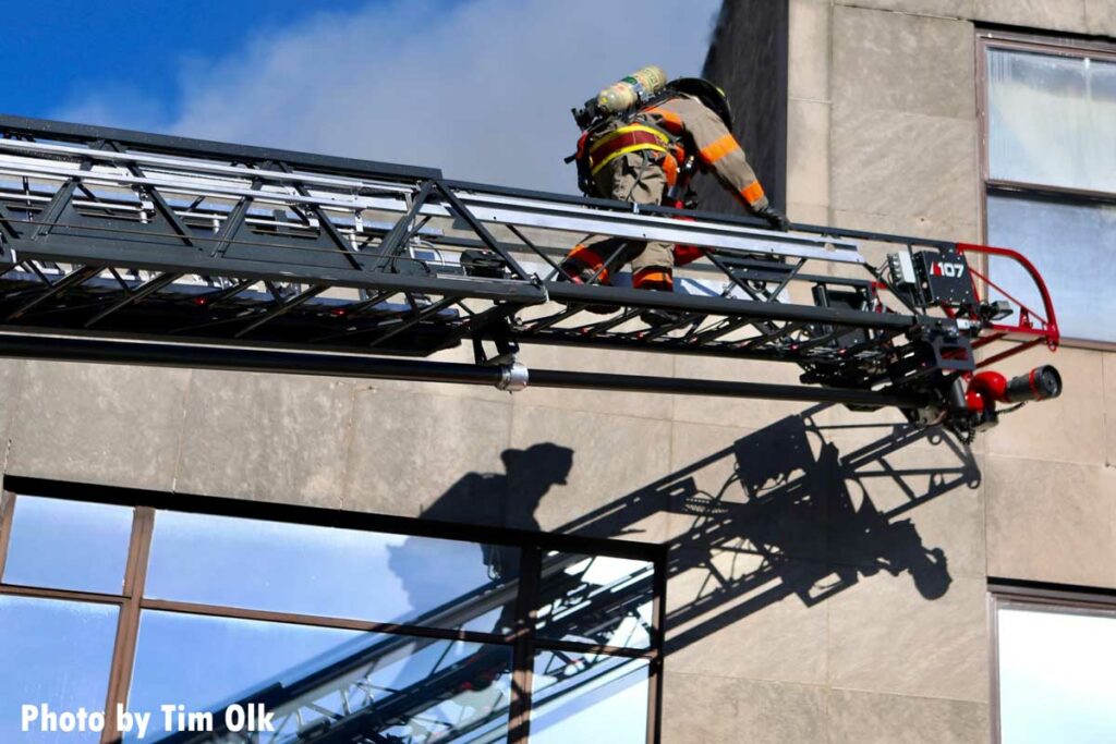 Firefighter ascends aerial ladder