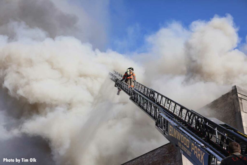 Elwood Park aerial ladder with firefighter and smoke