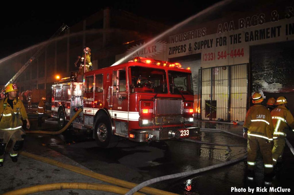 LAFD firefighters on fire truck at commercial fire