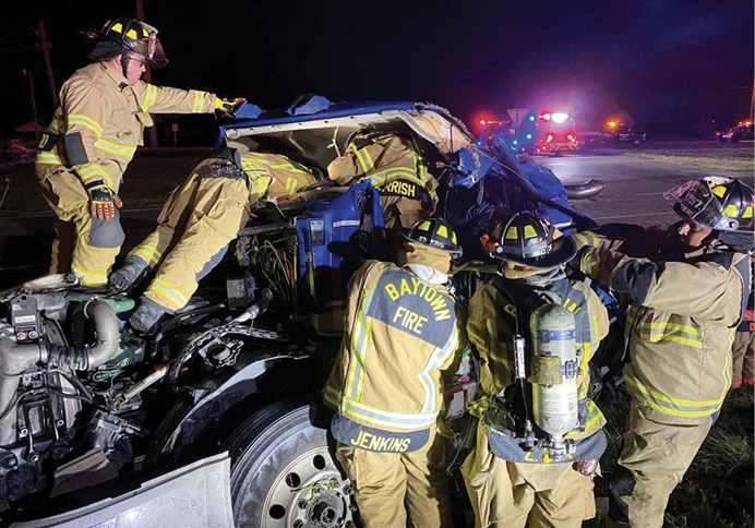 Crew members work to extricate the entrapped driver, which they accomplished 15 minutes after arrival.