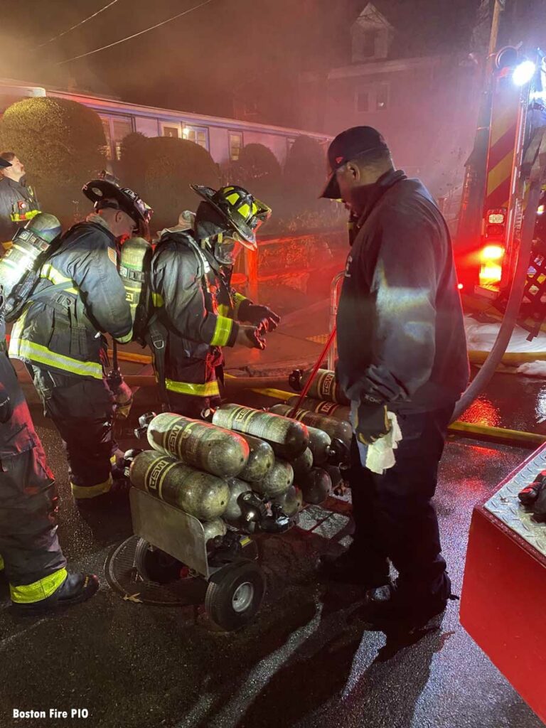 Boston firefighters with pile of SCBA