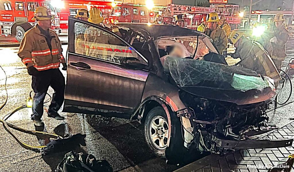 LAD firefighters work to extricate victim pinned in car