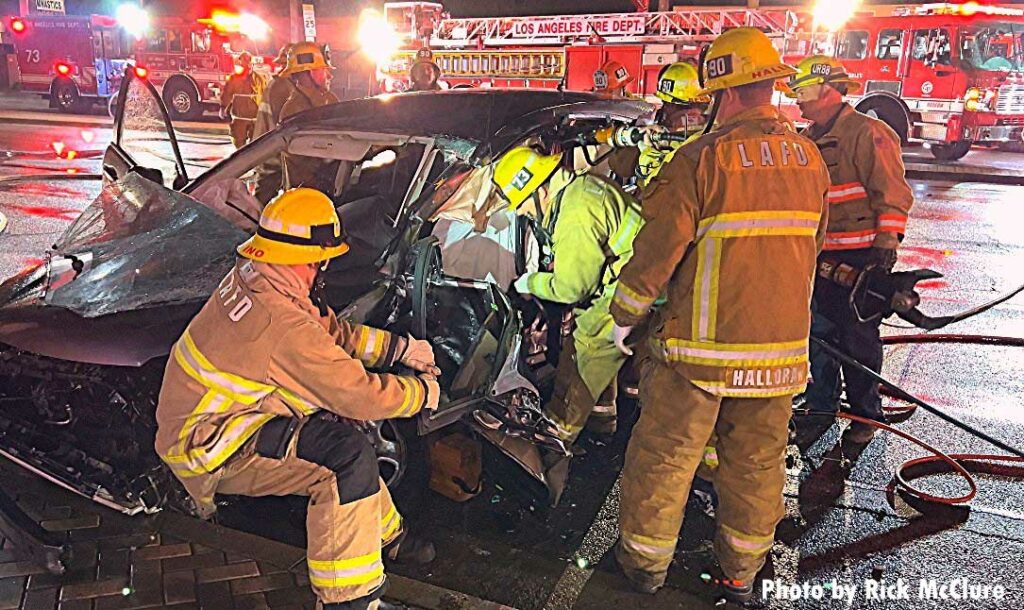 Firefighters work to remove victim at vehicle crash