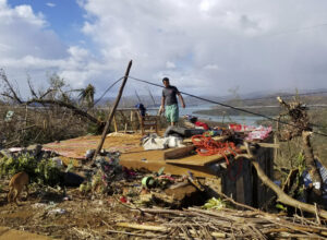 A man checks his damaged home due to Typhoon Rai at Dinagat islands, southern Philippines on Sunday Dec. 19, 2021.