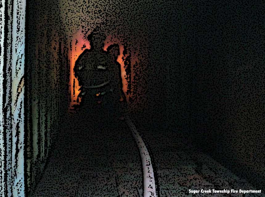 Firefighters down a dark hallway