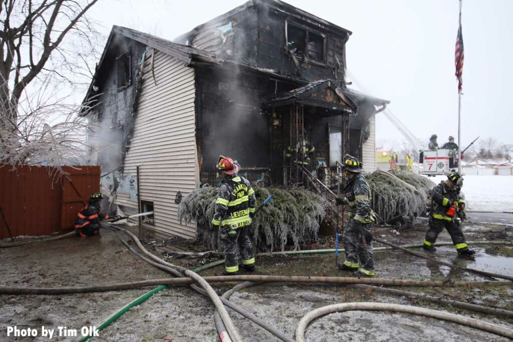 Multiple hoselines stretched at burned home