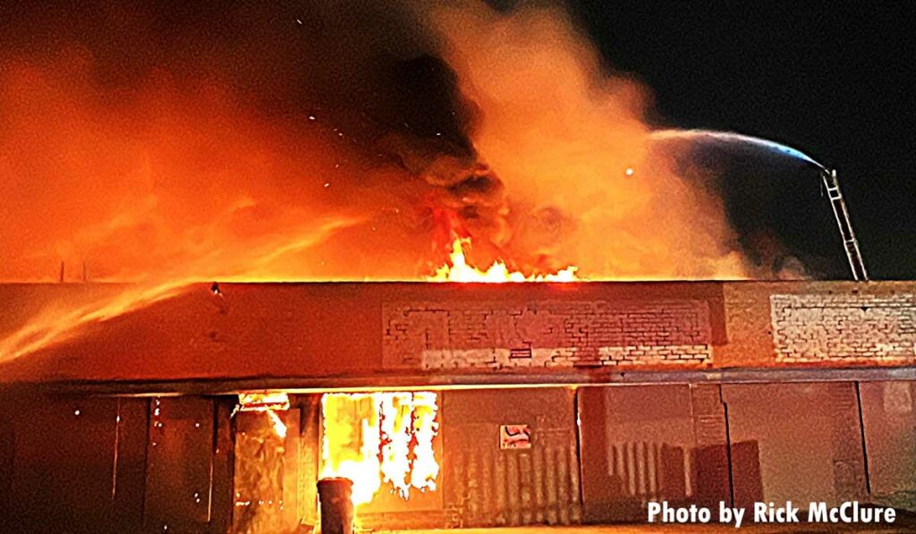 Flames through the roof with an elevated water stream