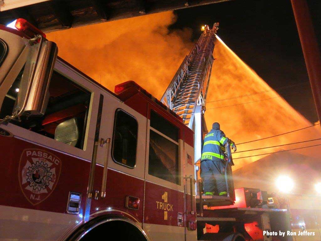 Passaic firefighter with Truck 1 and elevated master stream