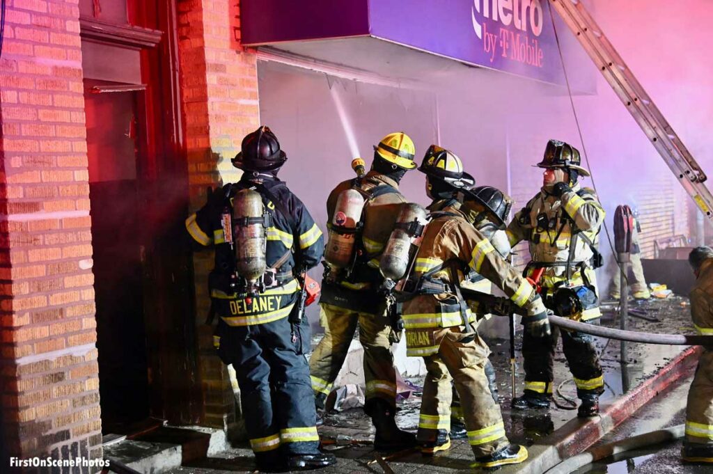 Firefighters put hose stream inside building at Mineola fire