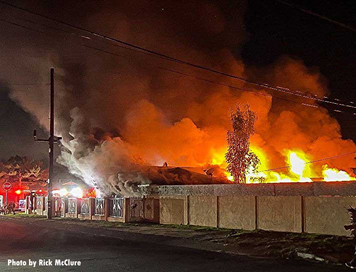 Flames and smoke shoot from a large residential structure in Los Angeles, California