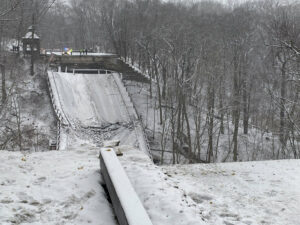 The photo shows a snow covered bridge that collapsed.