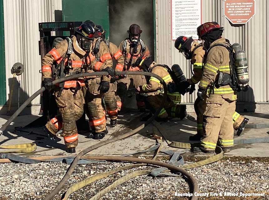 Firefighter recruits engage in live fire training.