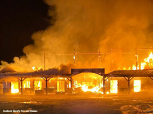 Flames tear through a heavy timber residential style barn