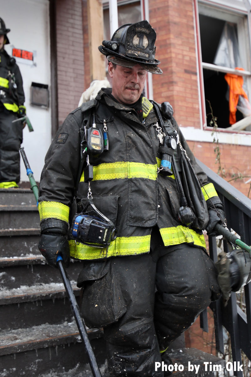 Chicago firefighter with tool descending stairs