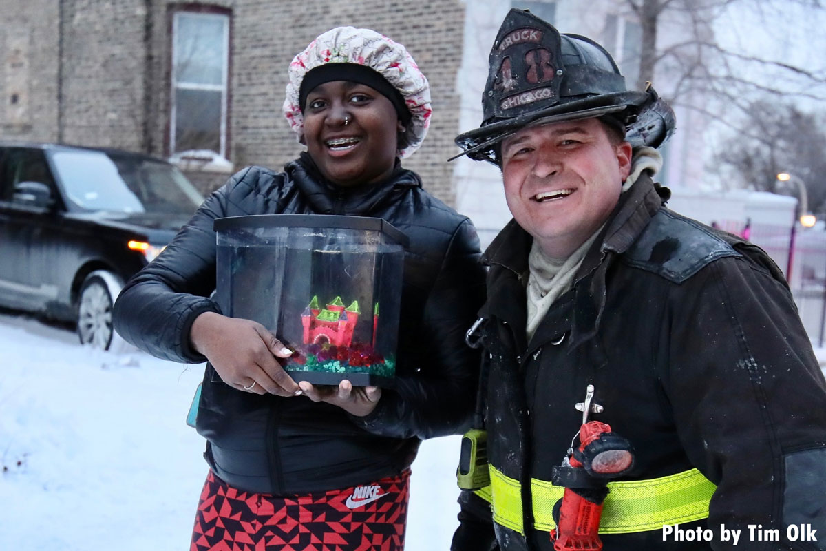 Chicago firefighter with civilian and rescue fish