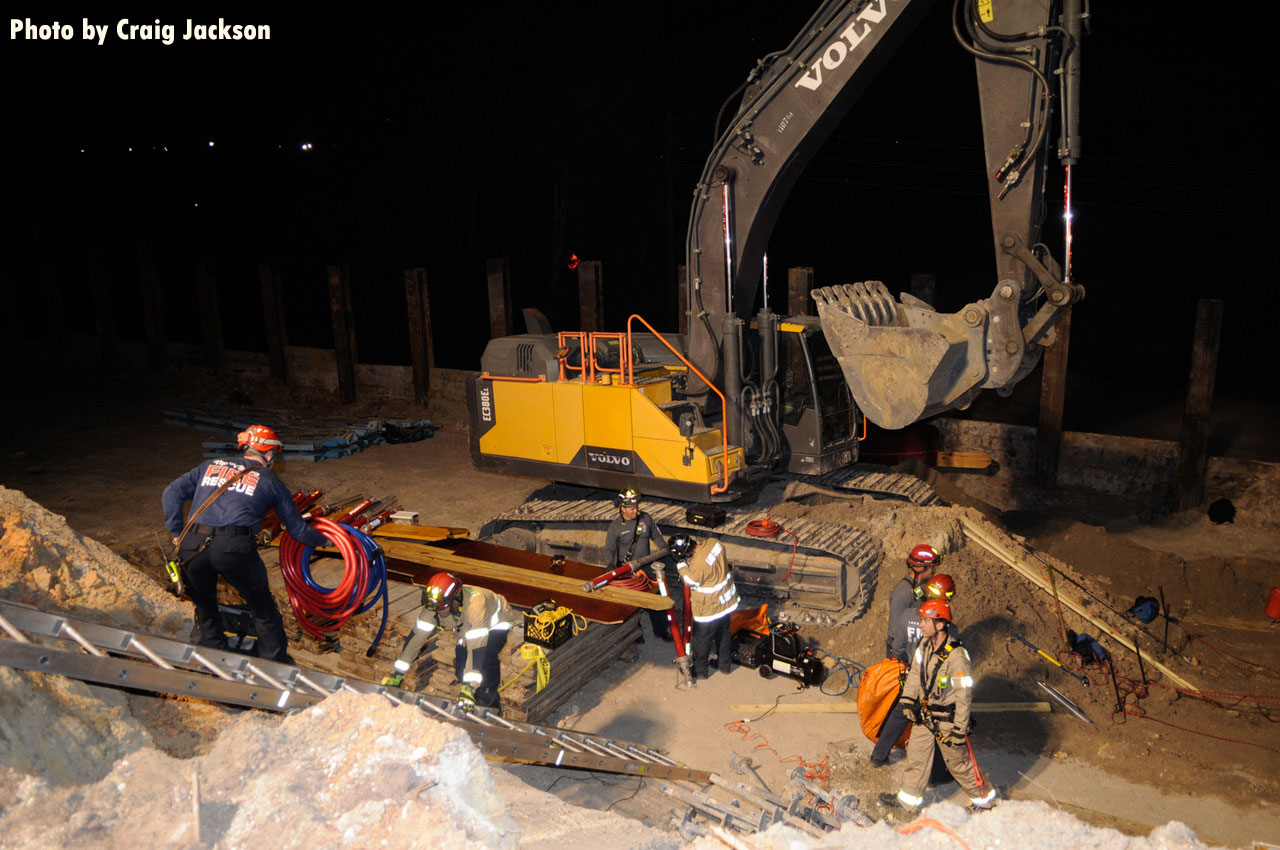 Firefighters bring rescue equipment down to rescue site