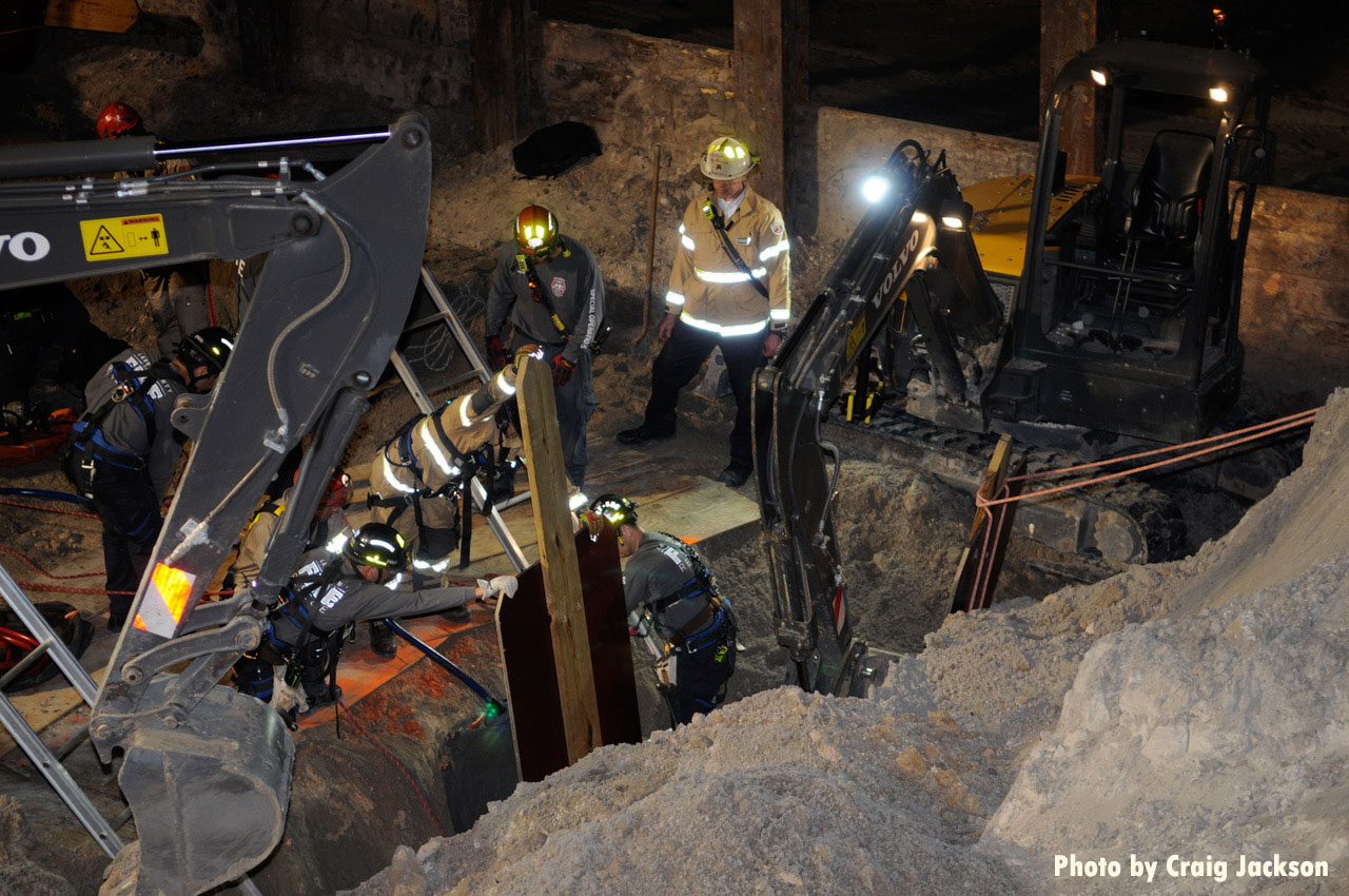 Firefighter use min excavator to dig at rescue scene