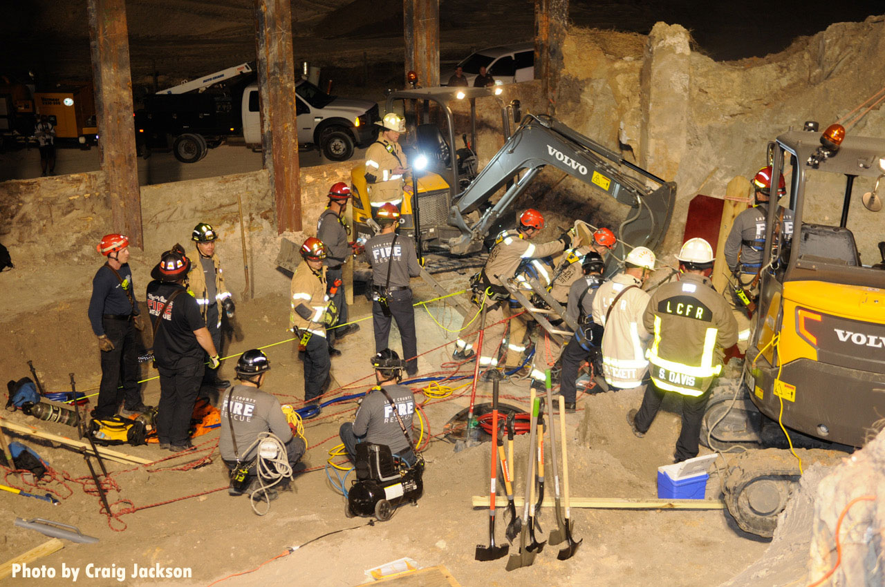 Firefighters with construction devices at trench rescue