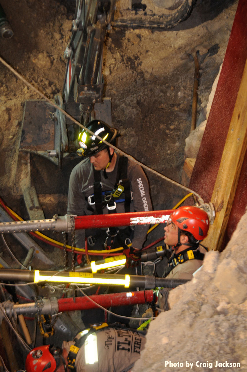 Florida firefighters use equipment to shore up sides of trench