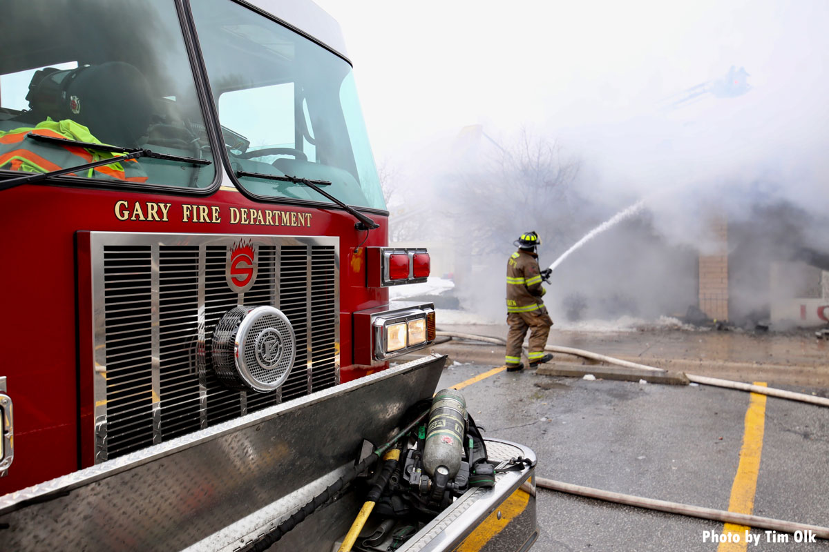 Gary IN fire truck and firefighter with hose