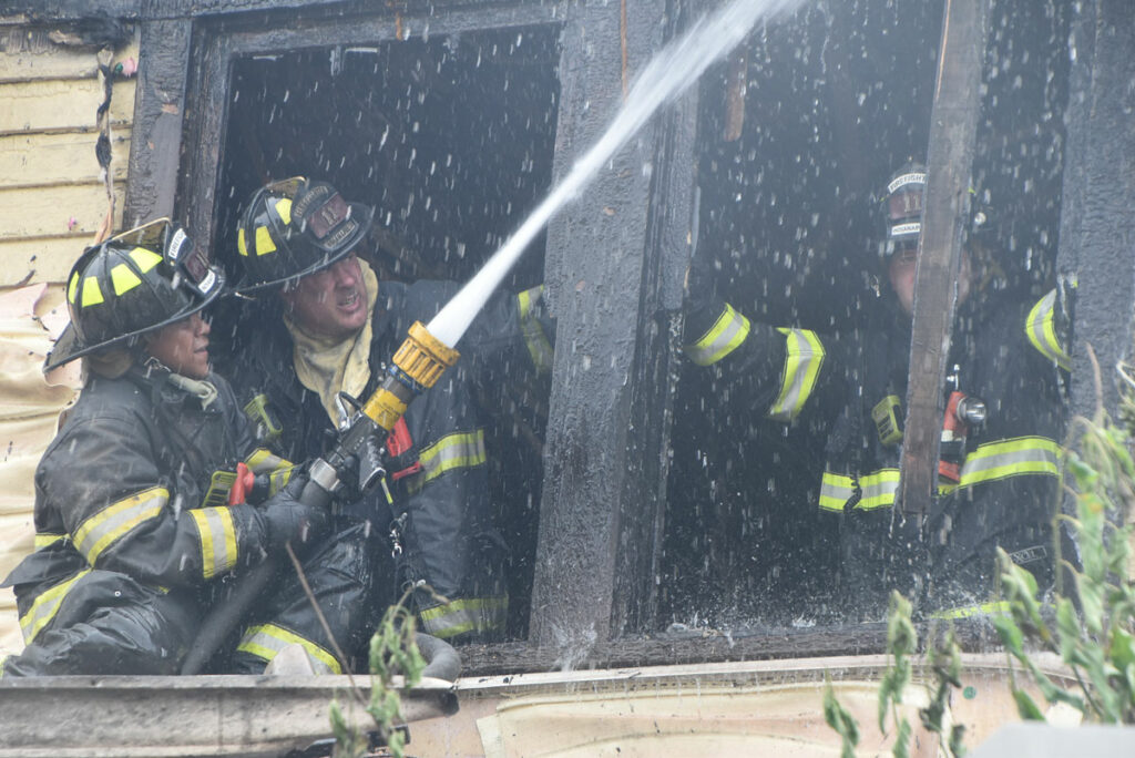 Indianapolis firefighters put water on fire