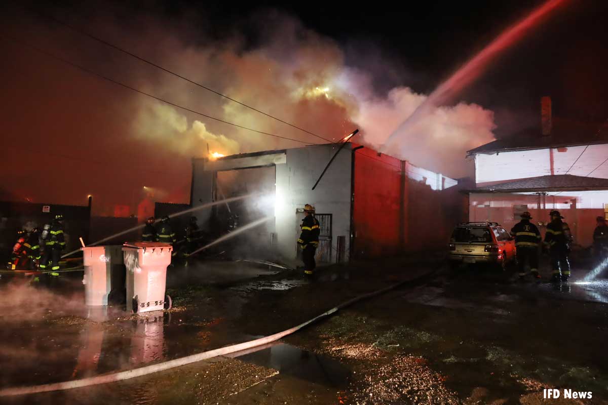 Firefighters put multiple water streams in rear of building