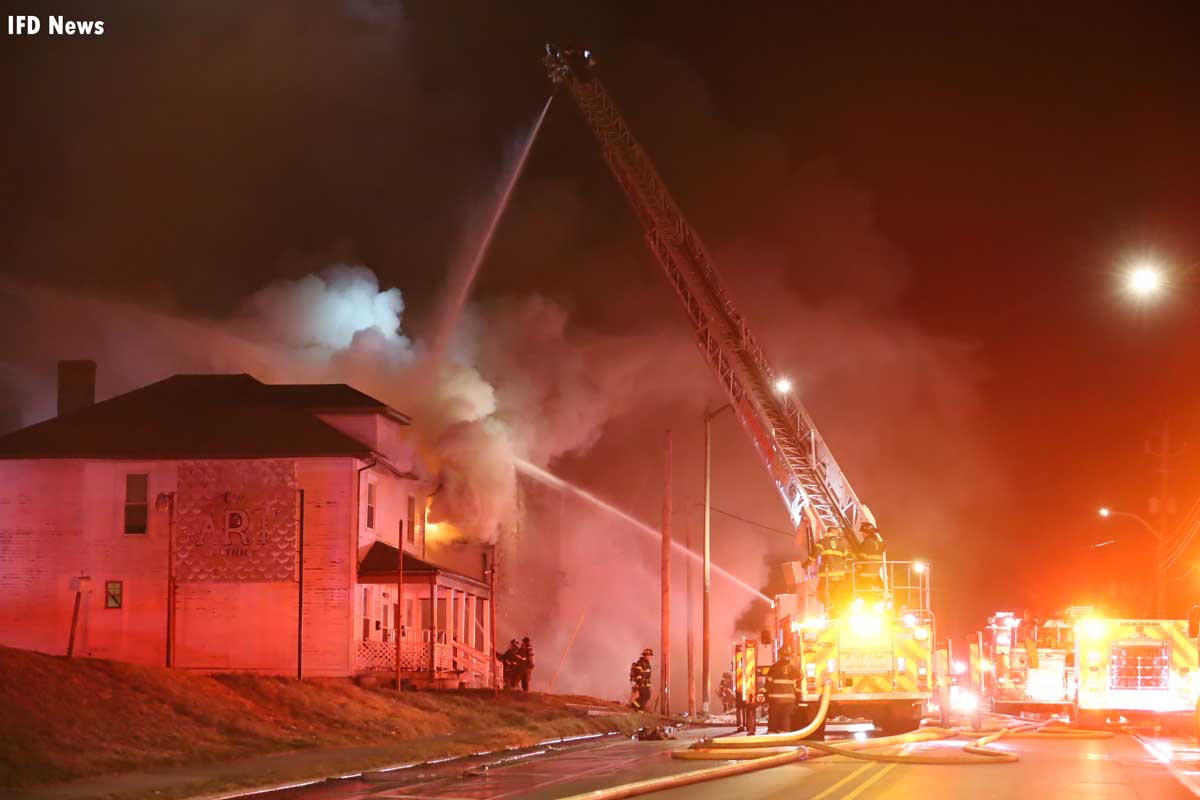 Long shot of tower ladder flowing water at Indianapolis structure fire