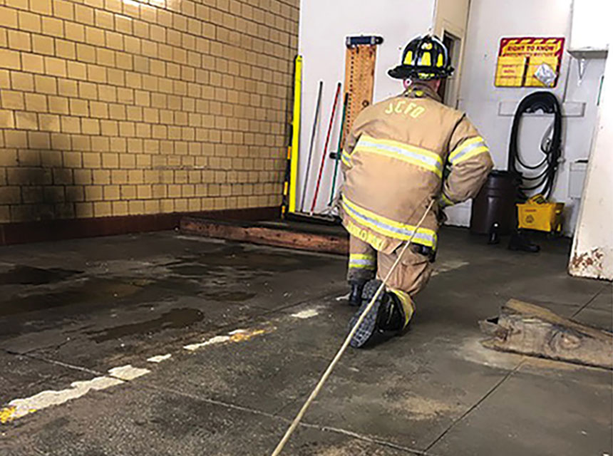 Firefighters on a rope searching