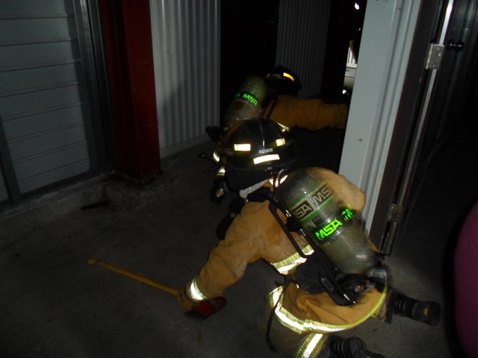 Firefighter navigates through burn building