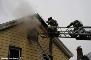 Two Hackensack firefighters on aerial ladder