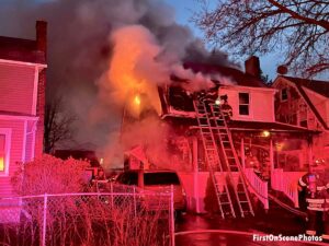 Two ladders with firefighters at Hempstead house fire