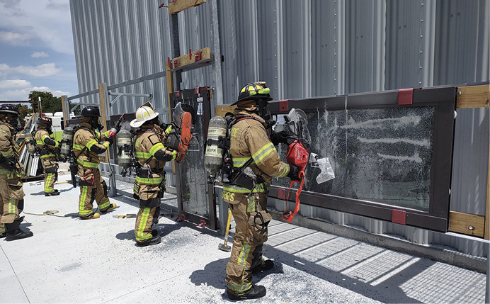 Firefighters cutting glass on training props