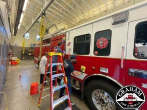 Graham WA firefighters clean a fire truck