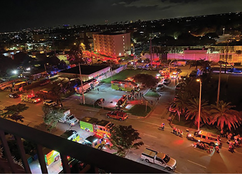 A view of Collins Avenue looking south and the command post in the parking lot across from the building on Collins Avenue.