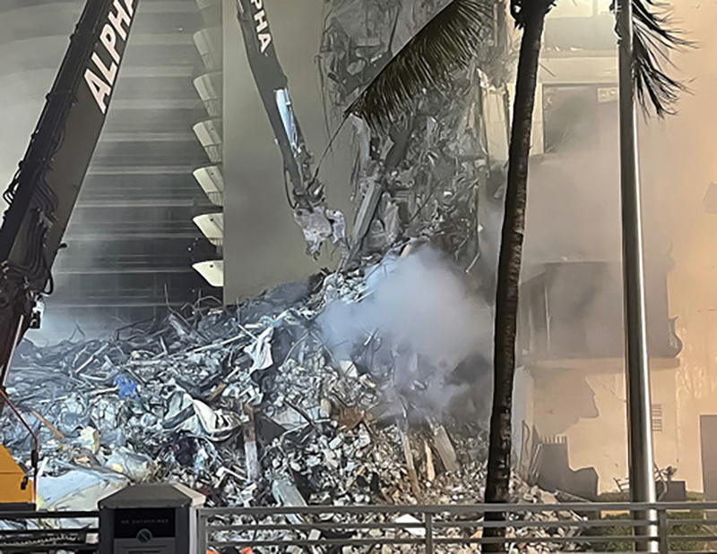 The “nibbler” meticulously removed debris in an attempt to cut a break in the rubble pile before the fire took possession of the entire collapse site.