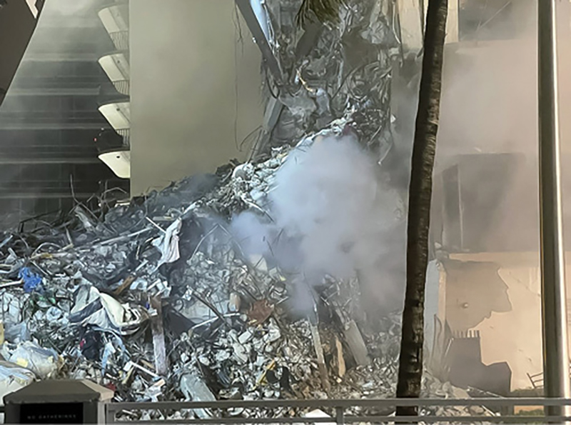 The “nibbler” meticulously removed debris in an attempt to cut a break in the rubble pile before the fire took possession of the entire collapse site.