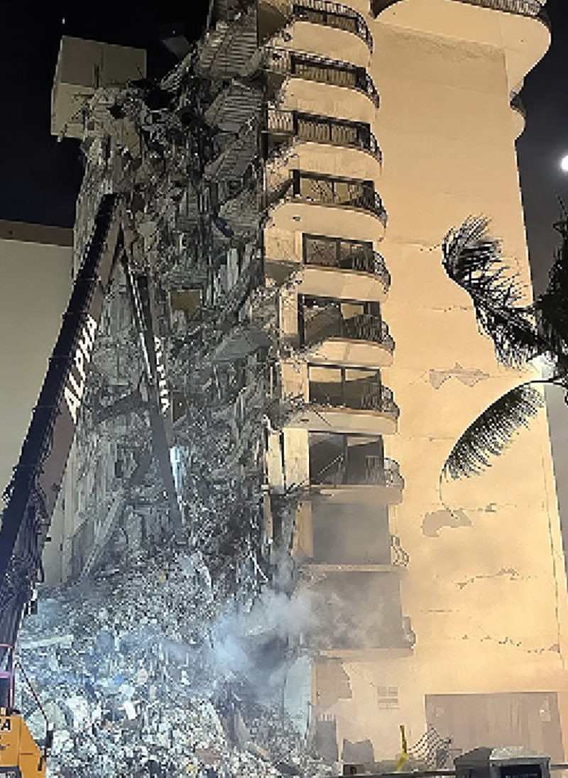 The “nibbler” meticulously removed debris in an attempt to cut a break in the rubble pile before the fire took possession of the entire collapse site.