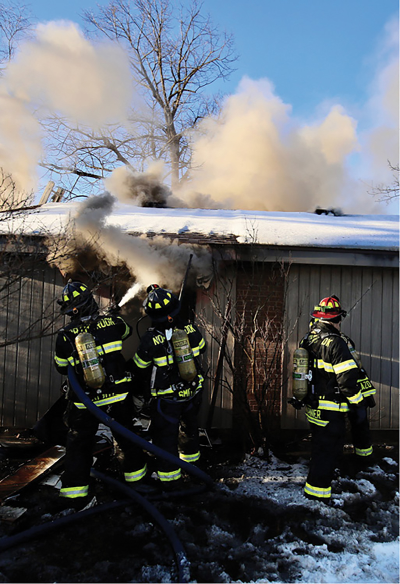 Fire is knocked down by a hoseline in the rear.