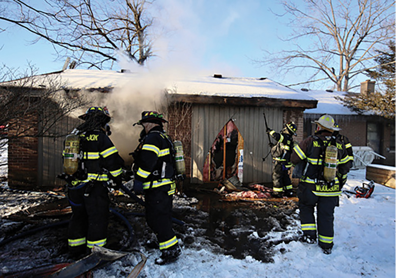 Cuts made on the exterior walls of the garage in the rear expose possible pockets of fire. Because the fire is up in the roof space, these walls are opened up.