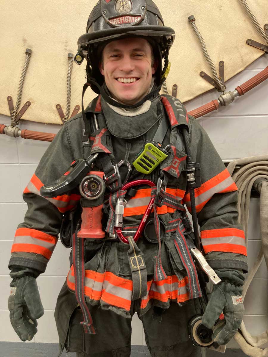 Firefighter adjusts gear for rescue