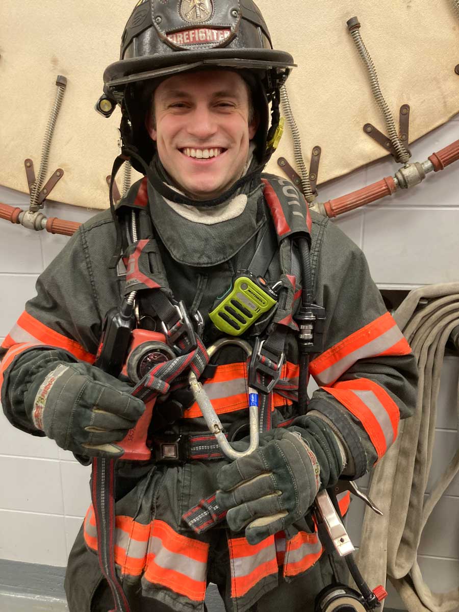 Smiling firefighter with SCBA adjustments