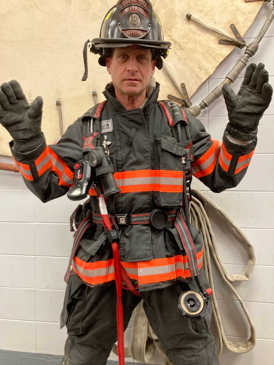 Firefighter with SCBA and hands up