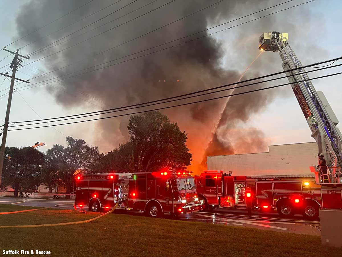 Suffolk VA fire pumper and tower ladder with elevated master stream at commercial fire