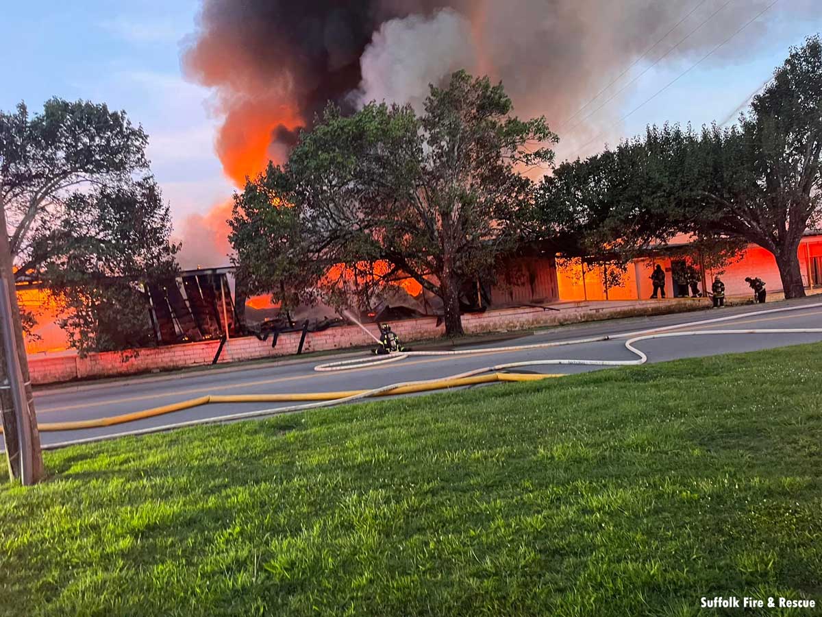 Firefighter uses hose stream from ground as flames ravage Suffolk building