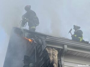 Boston firefighters on roof at Norton Street fire