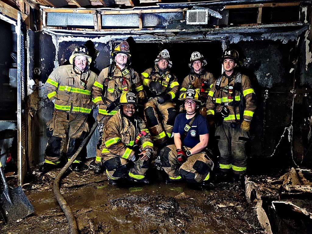 Firefighters inside burnt out structure