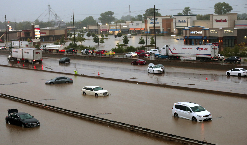 Abandoned cars are scattered by flooding across a shuttered Interstate 70 at Mid Rivers Mall Drive in St. Peters after heavy rain fell through the night.