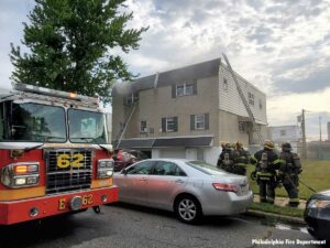 Philadelphia firefighters and fire truck at fire scene