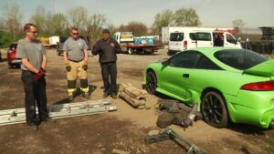 Firefighter use ladder as lever to lift car