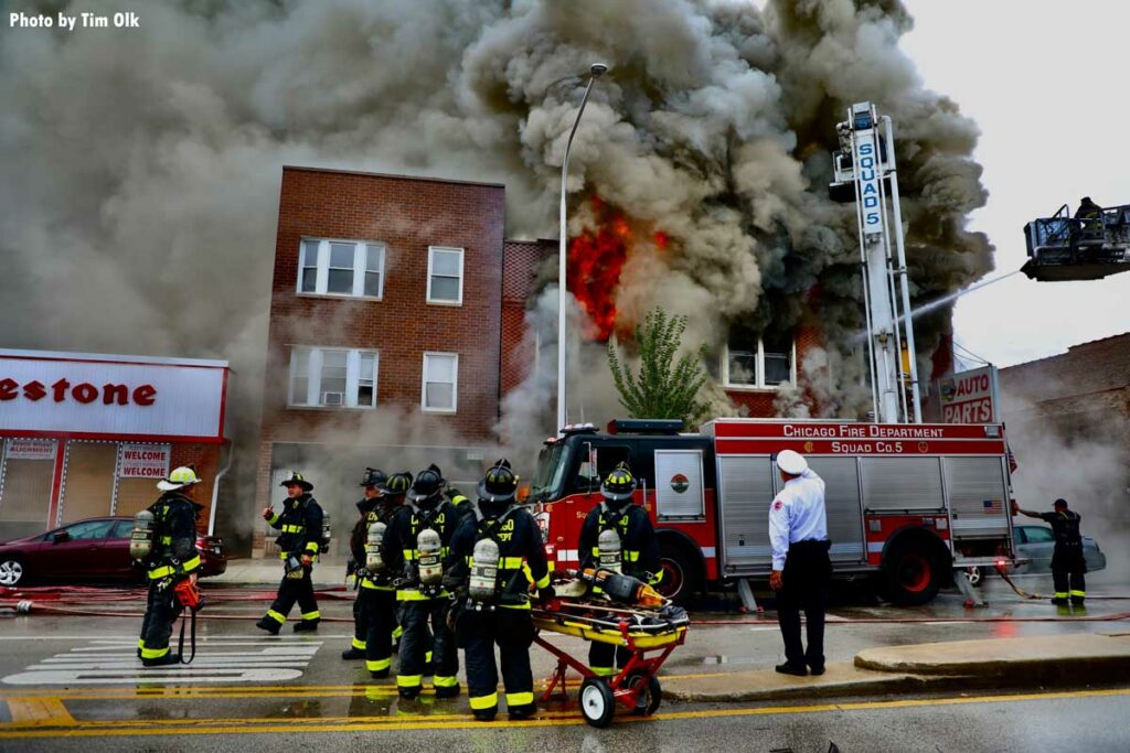 Flames erupt from top of building as Chicago Fire Squad 5 works